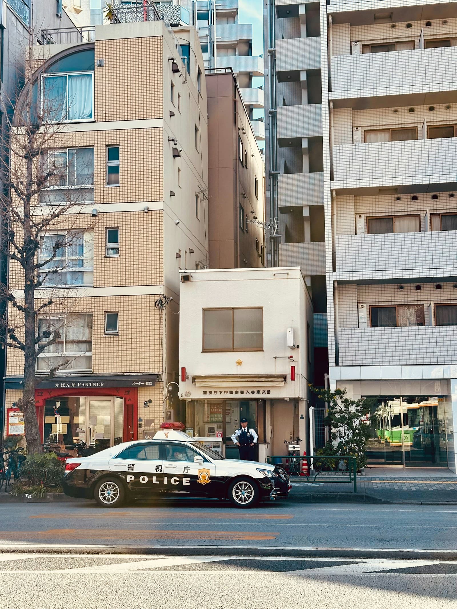 A police car parked in front of a tall building